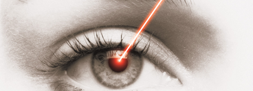 Close-up of an eye ball being struck by a laser beam